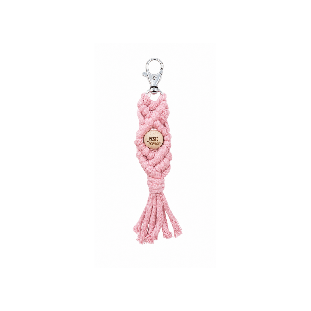 Handgemachter Schlüsselanhänger aus rosa Garn mit Holzperle und gelaserter Aufschrift „Beste Freundin“.